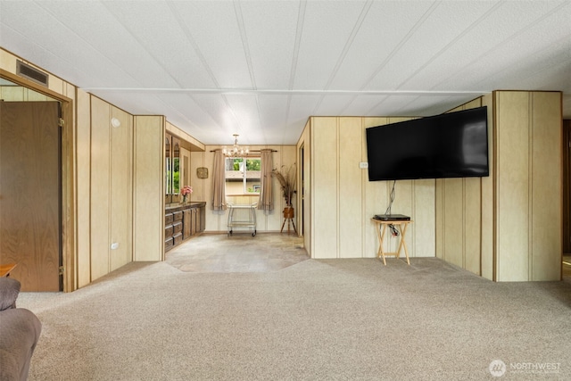 1171 E Trails End Dr, Belfair, WA 98528 - unfurnished living room featuring carpet and a chandelier