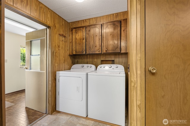 1171 E Trails End Dr, Belfair, WA 98528 - washroom featuring cabinet space, washer and clothes dryer, and wood walls
