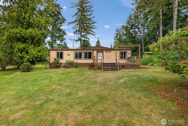 1171 E Trails End Dr, Belfair, WA 98528 - rear view of property with a wooden deck and a lawn