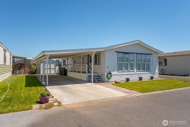 2240 W Broadway Ave Unit 25, Moses Lake, WA 98837 - manufactured / mobile home featuring a front yard, a carport, central AC unit, and driveway