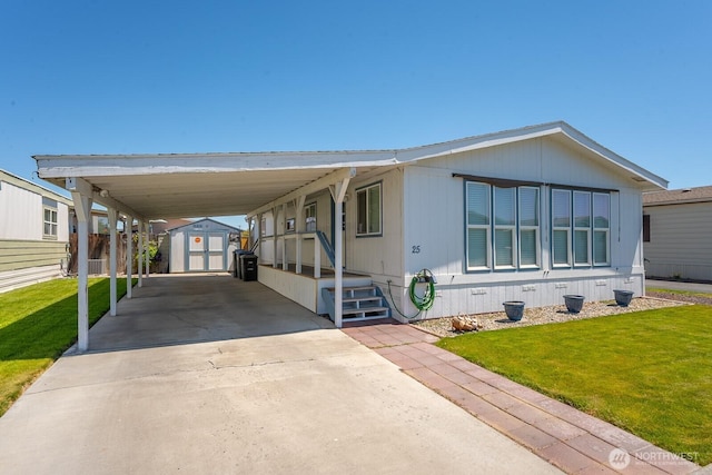 2240 W Broadway Ave Unit 25, Moses Lake, WA 98837 - manufactured / mobile home with a front lawn, driveway, and a carport
