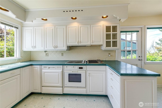 1415 E 2nd St, Port Angeles, WA 98362 - kitchen with oven, a peninsula, dishwashing machine, and decorative backsplash
