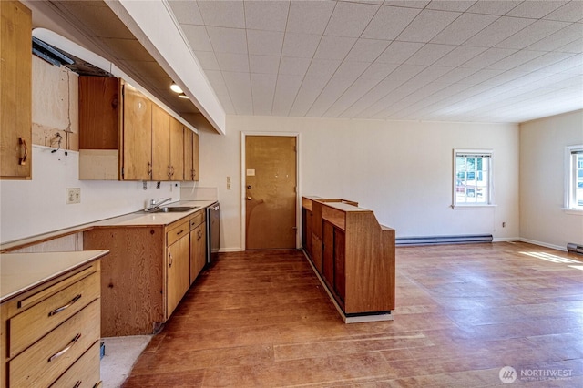 1415 E 2nd St, Port Angeles, WA 98362 - kitchen featuring brown cabinetry, light countertops, baseboard heating, light wood-type flooring, and stainless steel dishwasher