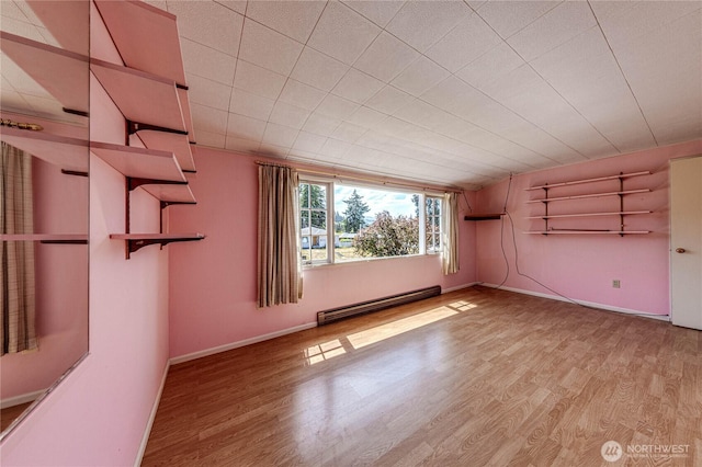1415 E 2nd St, Port Angeles, WA 98362 - unfurnished room with a baseboard radiator and light wood-style flooring