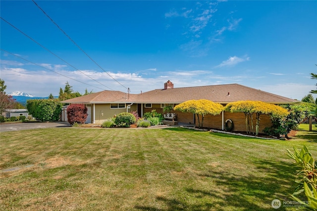 2483 Hilltop Rd, Ferndale, WA 98248 - ranch-style home featuring a chimney, a front lawn, asphalt driveway, and a garage