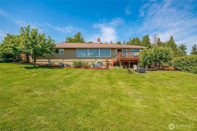 2483 Hilltop Rd, Ferndale, WA 98248 - rear view of house with a deck, a yard, and a chimney