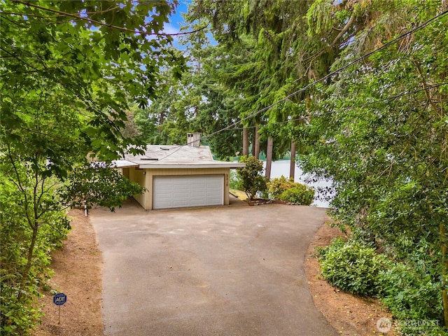 2219 Yelm Hwy SE, Olympia, WA 98501 - view of front of property with asphalt driveway, a garage, and a chimney