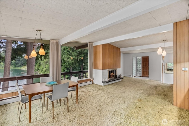 2219 Yelm Hwy SE, Olympia, WA 98501 - carpeted dining room featuring beam ceiling, a lit fireplace, and baseboard heating