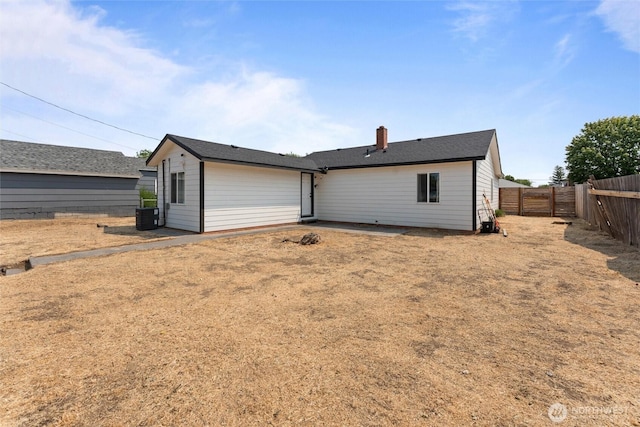 135 F St SE, Ephrata, WA 98823 - rear view of property with a fenced backyard and a chimney