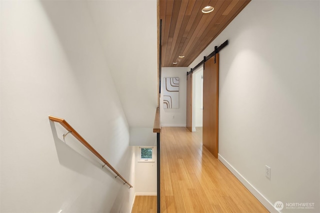 3659 Whitman Ave N, Seattle, WA 98103 - hallway featuring wooden ceiling, an upstairs landing, a barn door, recessed lighting, and light wood-type flooring