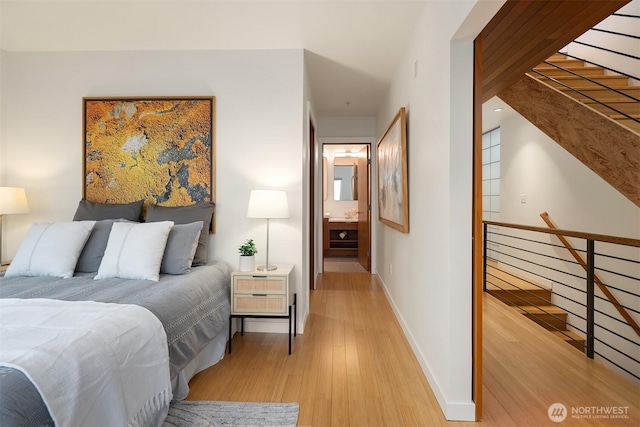 3659 Whitman Ave N, Seattle, WA 98103 - bedroom featuring light wood-style flooring and ensuite bathroom