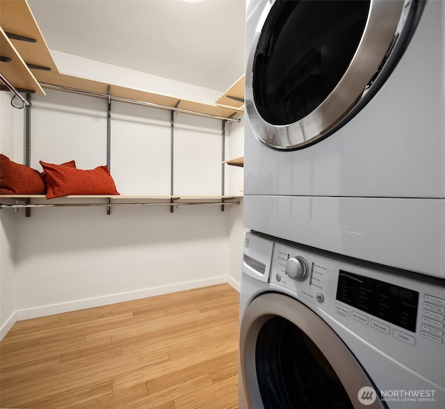 3659 Whitman Ave N, Seattle, WA 98103 - laundry area with stacked washing machine and dryer and light wood finished floors
