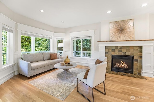 7516 181st Pl SW, Edmonds, WA 98026 - living room featuring light wood-style floors, a decorative wall, a tile fireplace, plenty of natural light, and recessed lighting