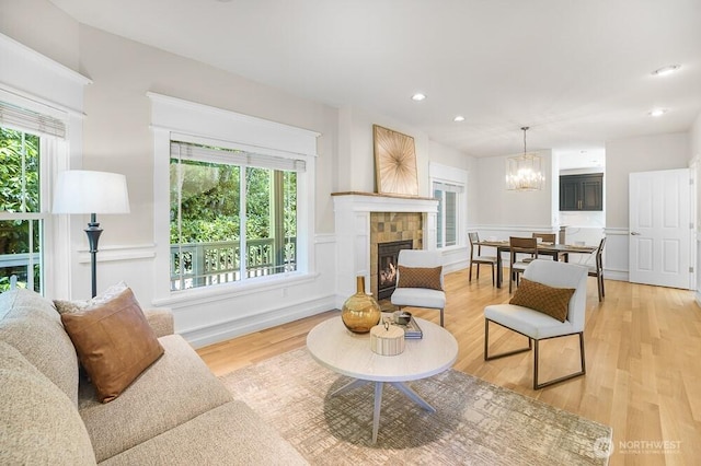 7516 181st Pl SW, Edmonds, WA 98026 - living area with healthy amount of natural light, light wood finished floors, a chandelier, recessed lighting, and a fireplace