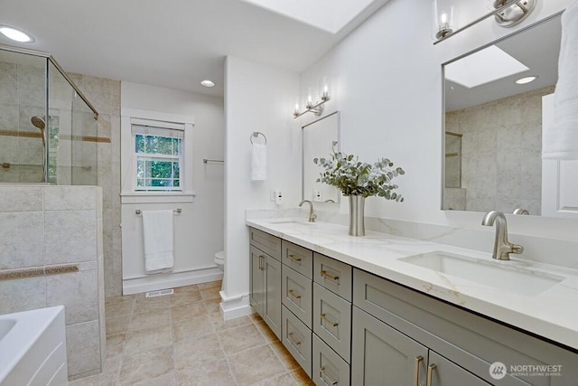 7516 181st Pl SW, Edmonds, WA 98026 - full bathroom with double vanity, a tile shower, a bath, tile patterned flooring, and a skylight