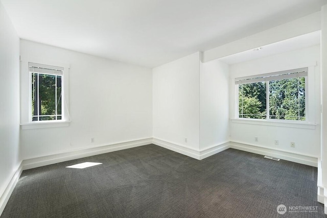 7516 181st Pl SW, Edmonds, WA 98026 - spare room featuring dark colored carpet and plenty of natural light