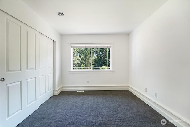 7516 181st Pl SW, Edmonds, WA 98026 - unfurnished bedroom with dark colored carpet and a closet