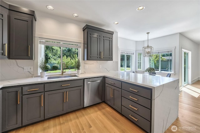 7516 181st Pl SW, Edmonds, WA 98026 - kitchen with stainless steel dishwasher, a peninsula, healthy amount of natural light, light wood finished floors, and recessed lighting