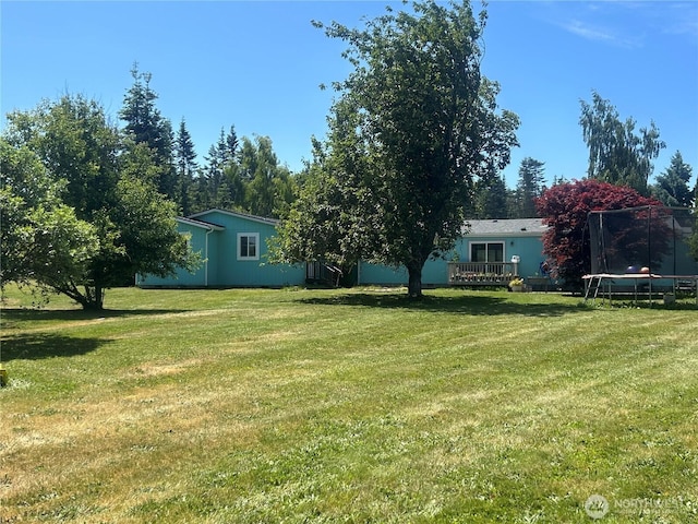 72 Misty Glen Ln, Sequim, WA 98382 - view of green lawn with a trampoline and a deck