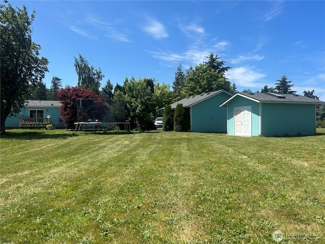 72 Misty Glen Ln, Sequim, WA 98382 - view of green lawn featuring a trampoline and a storage unit
