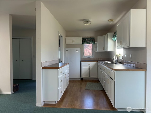 72 Misty Glen Ln, Sequim, WA 98382 - kitchen with freestanding refrigerator, white cabinetry, and dark wood-type flooring