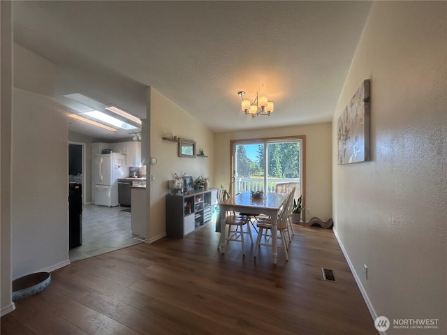 72 Misty Glen Ln, Sequim, WA 98382 - dining area featuring wood finished floors and a chandelier
