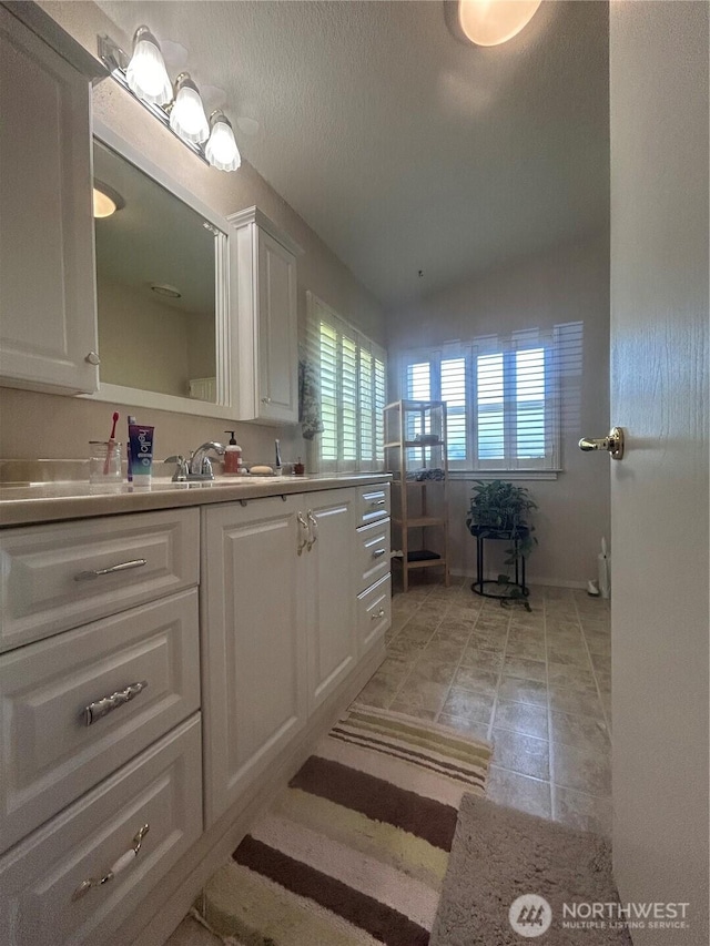 72 Misty Glen Ln, Sequim, WA 98382 - bathroom featuring vanity, vaulted ceiling, a textured ceiling, and tile patterned floors
