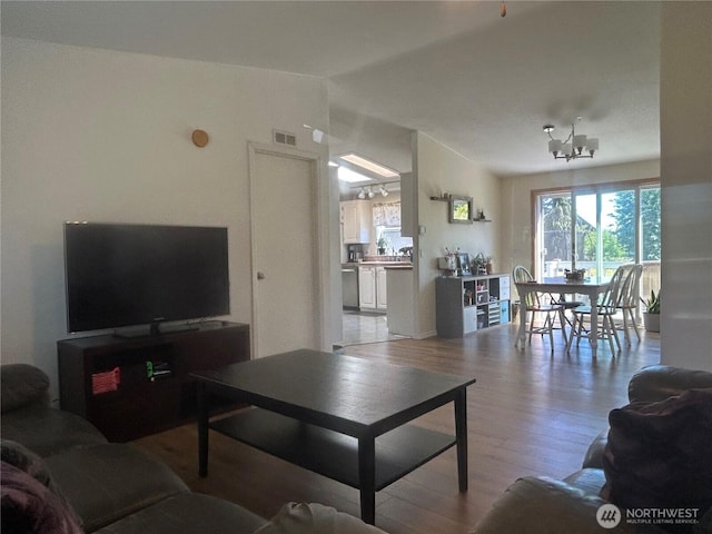 72 Misty Glen Ln, Sequim, WA 98382 - living area with light wood-style floors, a chandelier, and vaulted ceiling