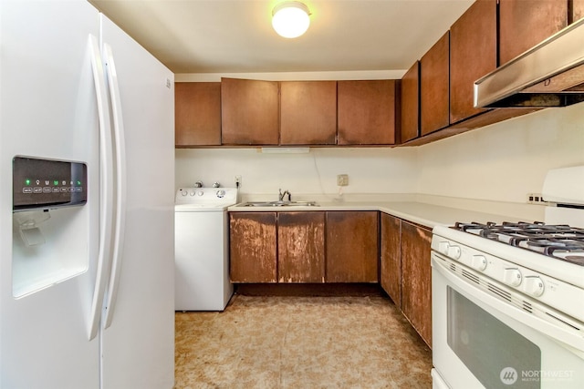 26622 190th Ave SE, Covington, WA 98042 - kitchen featuring white appliances, exhaust hood, washer / clothes dryer, light countertops, and brown cabinetry