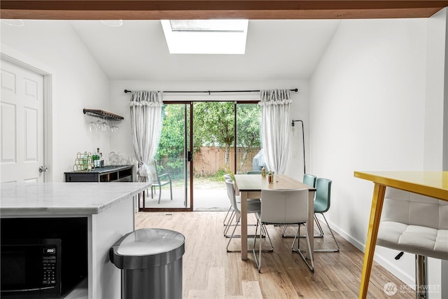 8739 17th Ave NW, Seattle, WA 98117 - dining space with light wood-style flooring and lofted ceiling
