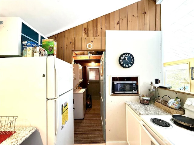 27805 L Pl, Ocean Park, WA 98640 - kitchen with white appliances, wood walls, and vaulted ceiling