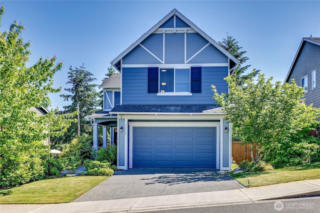 21598 NW Monterey Loop, Poulsbo, WA 98370 - view of front facade featuring driveway, a shingled roof, and a garage