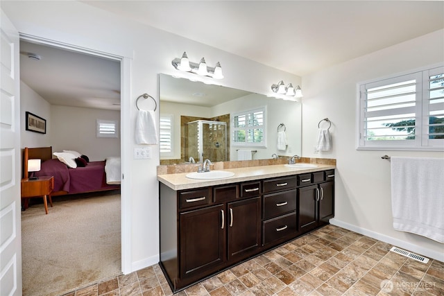 21598 NW Monterey Loop, Poulsbo, WA 98370 - bathroom featuring double vanity, healthy amount of natural light, a shower stall, and ensuite bathroom