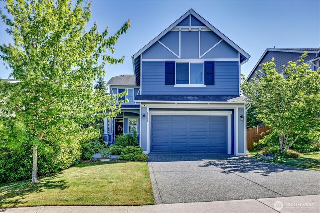 21598 NW Monterey Loop, Poulsbo, WA 98370 - view of front facade featuring concrete driveway, a garage, and roof with shingles