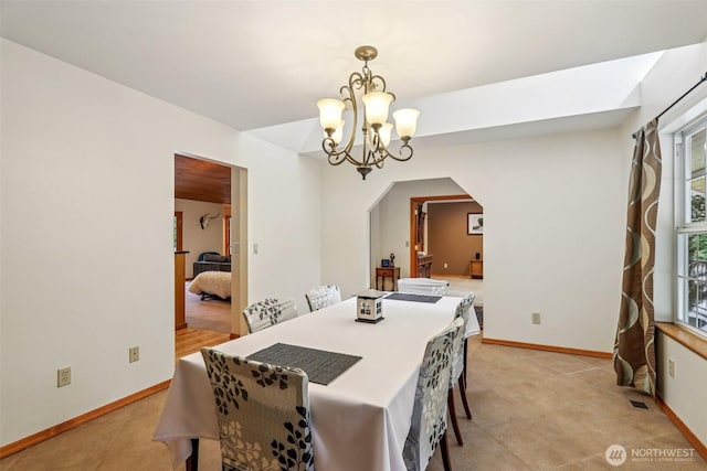 6611 Menzel Lake Rd, Granite Falls, WA 98252 - dining area with arched walkways, a chandelier, plenty of natural light, and light tile patterned flooring