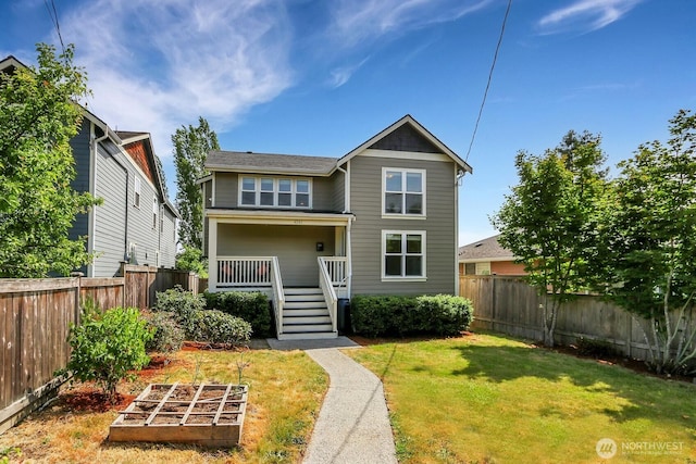 4241 S Eddy St, Seattle, WA 98118 - view of front of house with a vegetable garden, a fenced backyard, and stairway