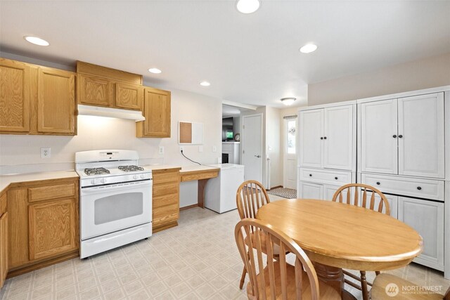 2735 Mcleod Rd, Bellingham, WA 98225 - kitchen featuring white gas range, under cabinet range hood, refrigerator, light flooring, and light countertops