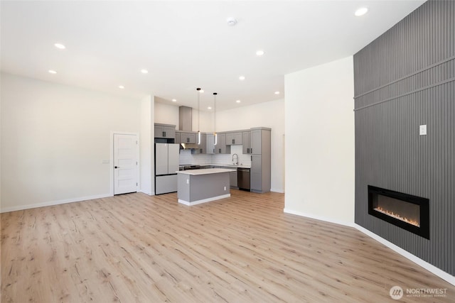 3124 Oas Dr W, University Place, WA 98466 - kitchen with gray cabinetry, open floor plan, stainless steel dishwasher, light wood-style floors, and recessed lighting