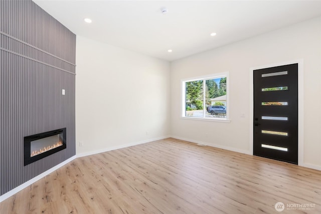 3124 Oas Dr W, University Place, WA 98466 - unfurnished living room with wood finished floors, recessed lighting, and a glass covered fireplace
