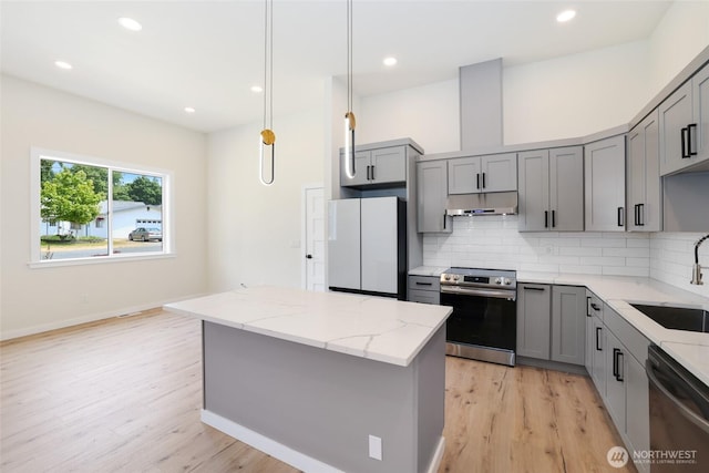 3124 Oas Dr W, University Place, WA 98466 - kitchen featuring appliances with stainless steel finishes, gray cabinetry, under cabinet range hood, light wood-style flooring, and recessed lighting