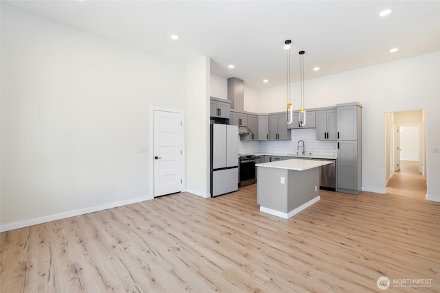 3124 Oas Dr W, University Place, WA 98466 - kitchen featuring appliances with stainless steel finishes, gray cabinets, light wood finished floors, light countertops, and recessed lighting