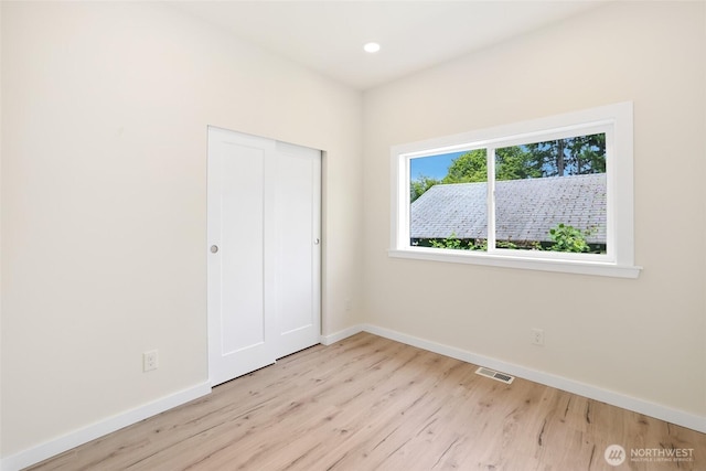 3124 Oas Dr W, University Place, WA 98466 - unfurnished bedroom featuring wood finished floors, a closet, and recessed lighting