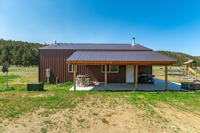 40359 Barbara Ln N, Davenport, WA 99122 - back of house featuring a patio, board and batten siding, a yard, and metal roof