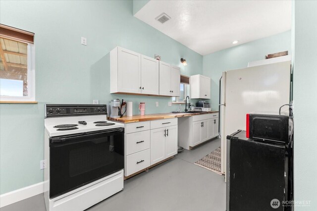 40359 Barbara Ln N, Davenport, WA 99122 - kitchen featuring electric stove, concrete floors, white cabinets, and a sink