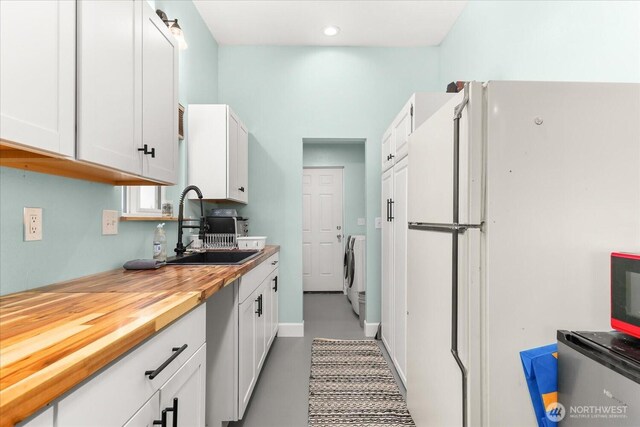 40359 Barbara Ln N, Davenport, WA 99122 - kitchen with freestanding refrigerator, a sink, white cabinets, wooden counters, and recessed lighting
