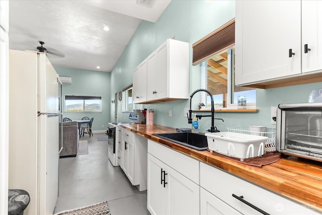 40359 Barbara Ln N, Davenport, WA 99122 - kitchen featuring wood counters, electric range, a sink, finished concrete floors, and freestanding refrigerator