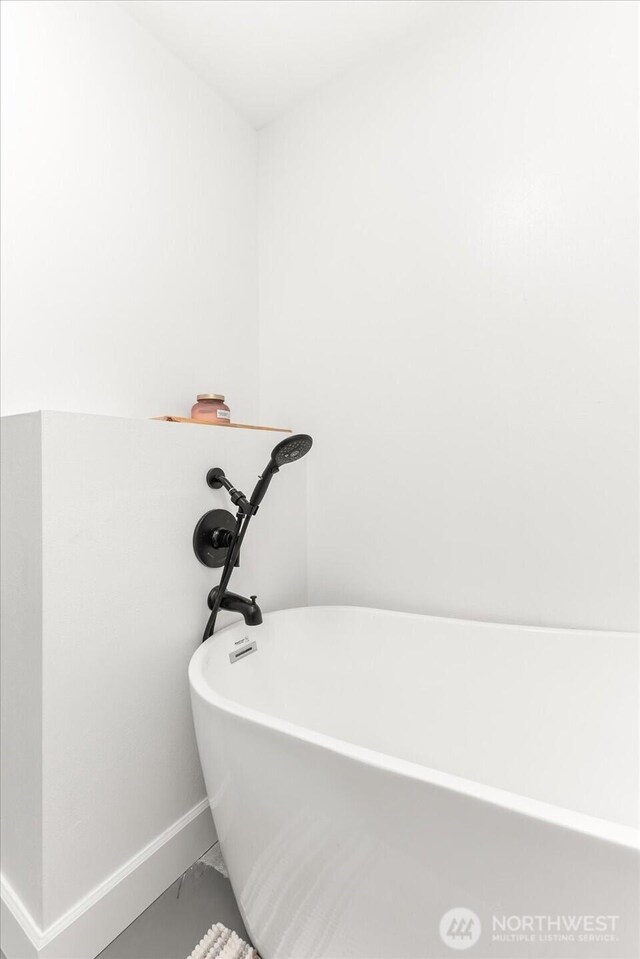 40359 Barbara Ln N, Davenport, WA 99122 - full bathroom with a soaking tub, baseboards, and marble look tiles
