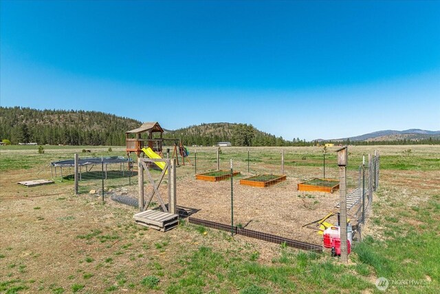 40359 Barbara Ln N, Davenport, WA 99122 - view of jungle gym with a vegetable garden, a rural view, and a mountain view