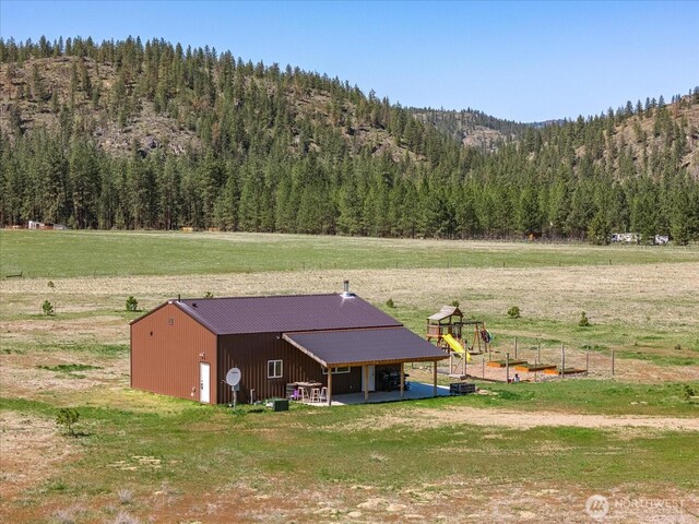40359 Barbara Ln N, Davenport, WA 99122 - view of pole building featuring a wooded view, a yard, and a playground