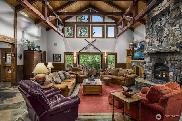 6286 Five Mile Rd, The Dalles, OR 98058 - living room featuring high vaulted ceiling, a wooden ceiling with exposed beams, wainscoting, a fireplace, and healthy amount of natural light